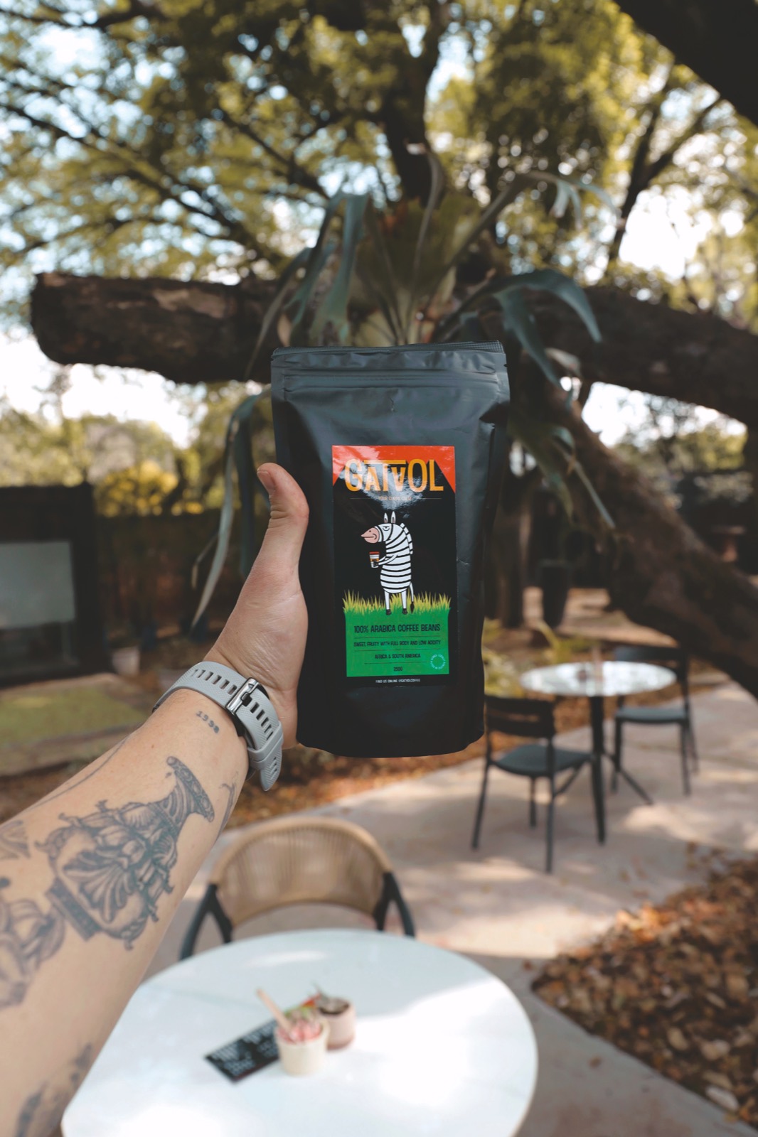 A bag of Gatvol Coffee beans held in the Centurion garden